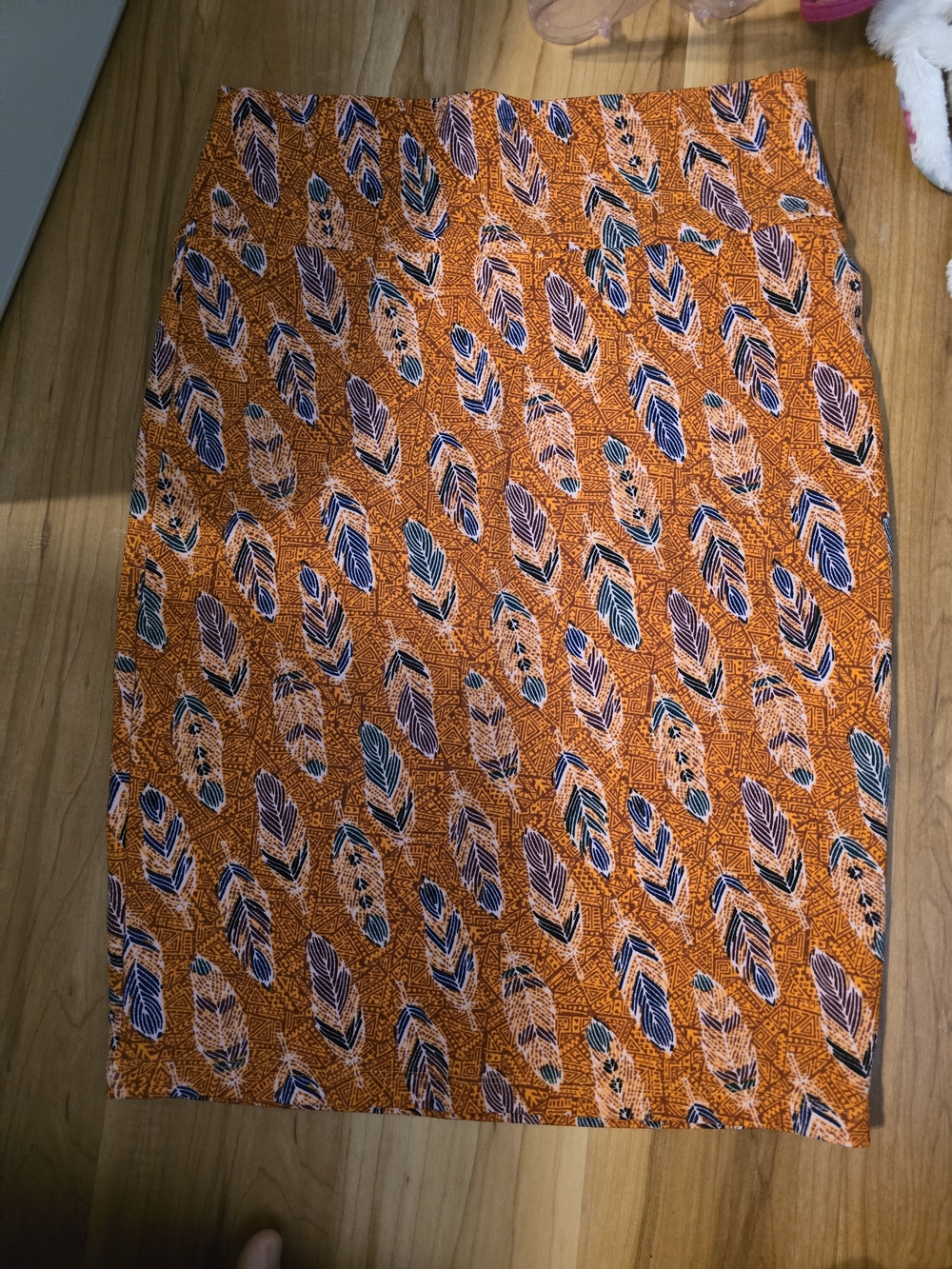 LuLaRoe Orange Printed Pencil Skirt with Navy and Cream Feather Motif